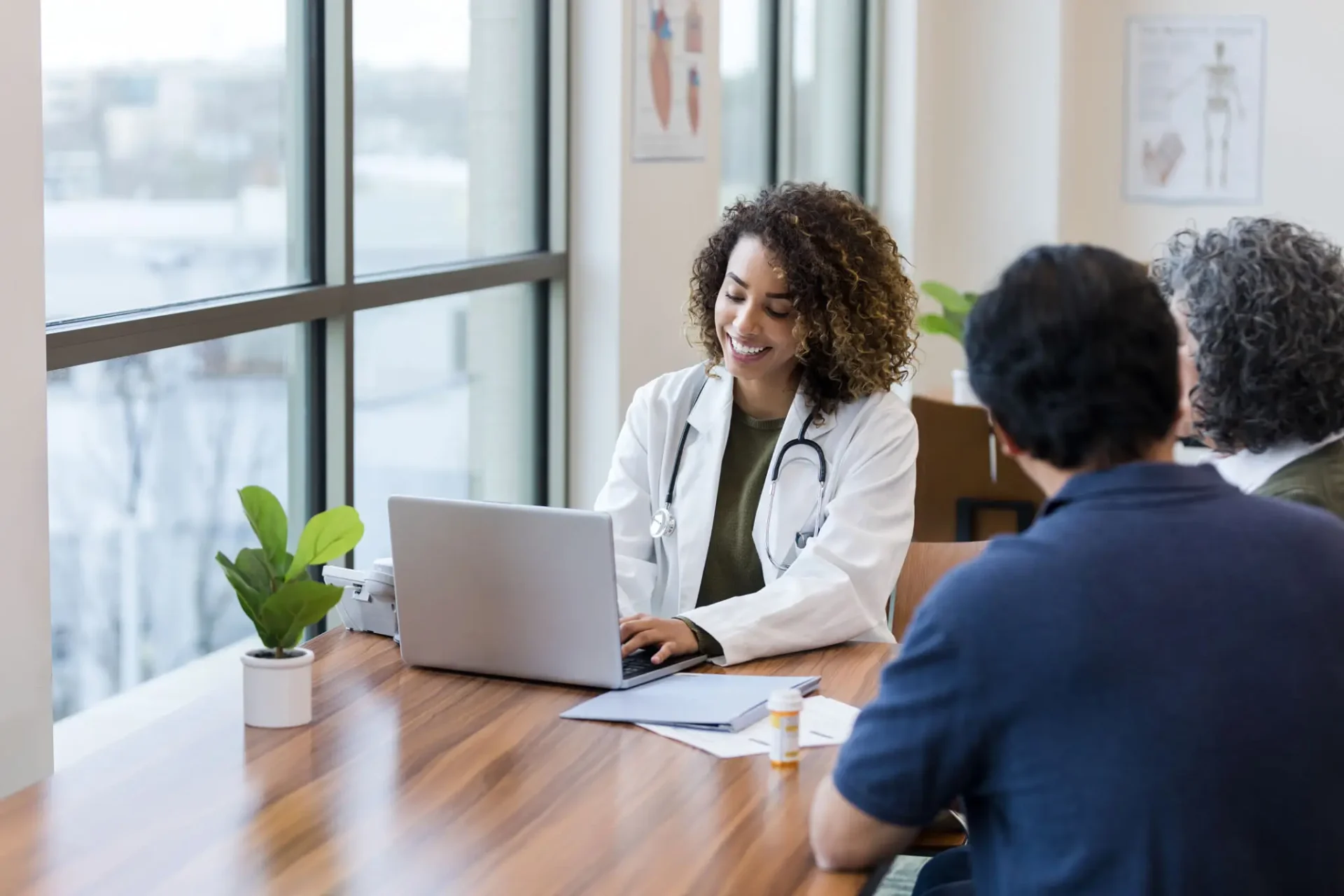 Doctor consulting patients in a bright office